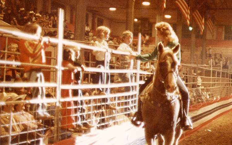 Reba on horse talks to children in the audience 